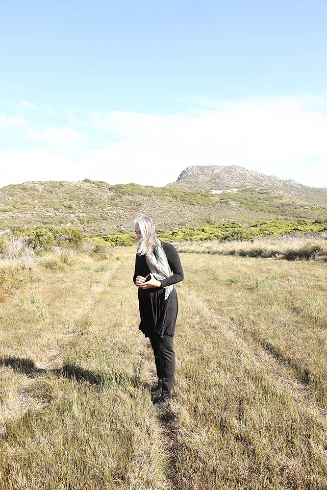 Lien Botha dressed in black meandering through the fynbos veld